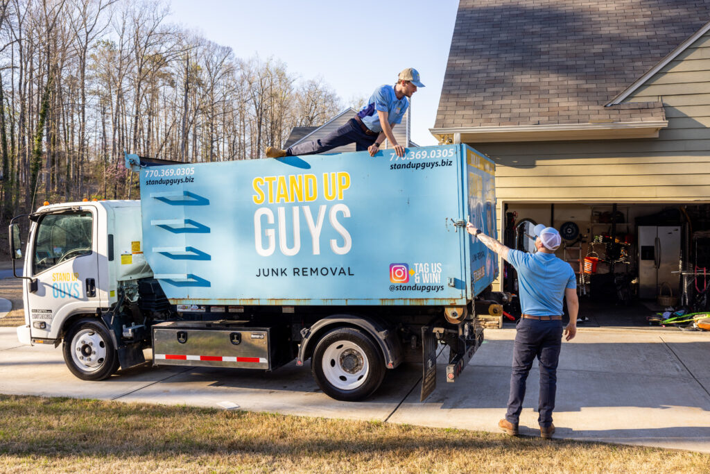 junk removal company in front of a home, preparing truck