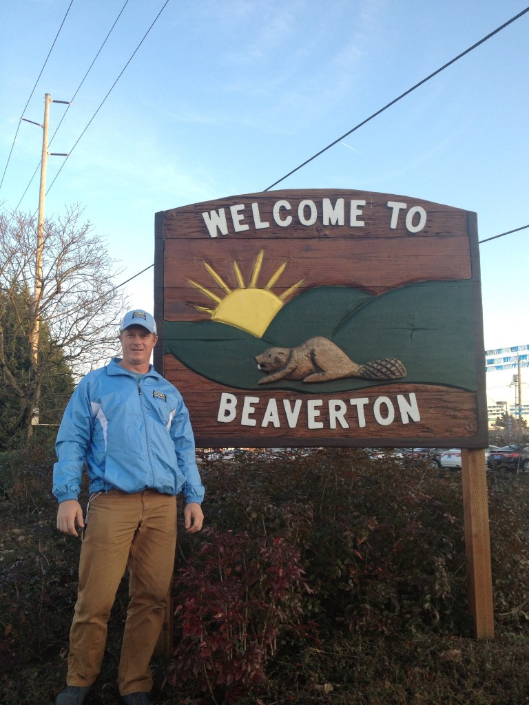 man standing in front of beaverton oregon sign