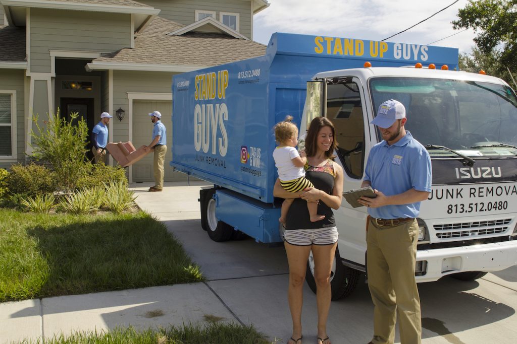 junk removal company in plano helping out a customer with a baby