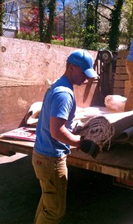 man loading carpet into truck