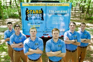 stand up guys junk removal crew standing in front of a truck