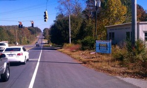 property clean up sign on side of the road