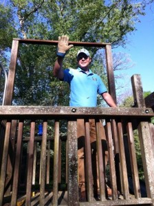 man waving on play set