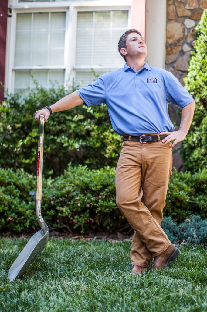 ross lawrence of stand up guys standing with a shovel