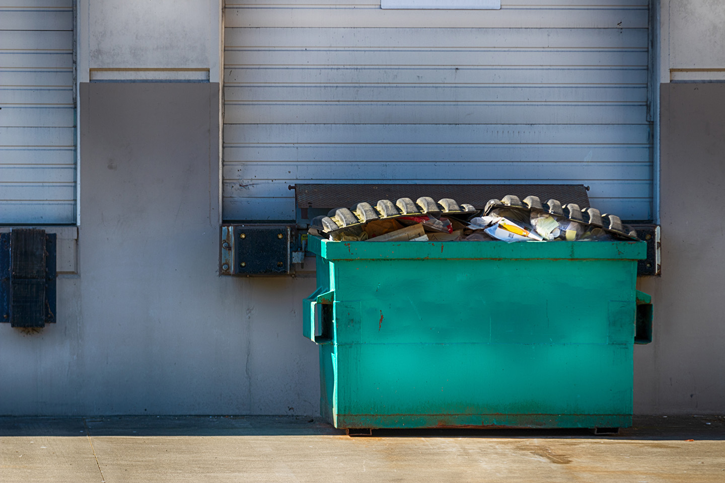 Commercial junk dumpster at loading dock