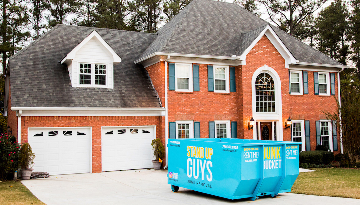 junk bucket in driveway of home